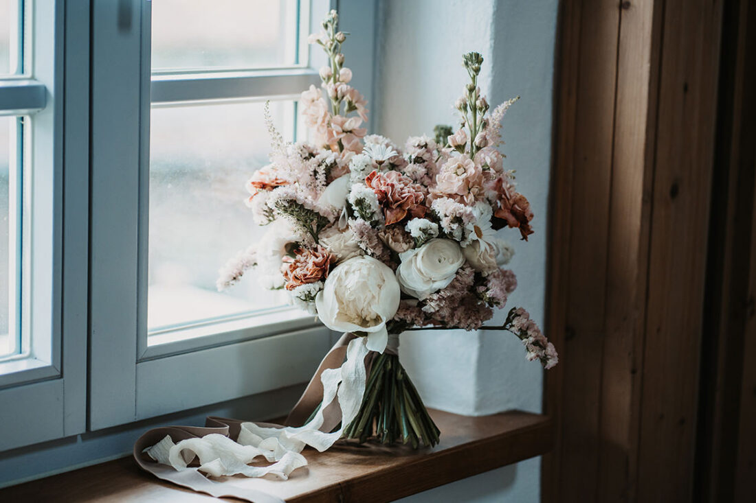 Brautstrauß lehnt an Fenster auf dem Hofgut Maisenburg - Hochzeitsfotograf Patricia Hamann