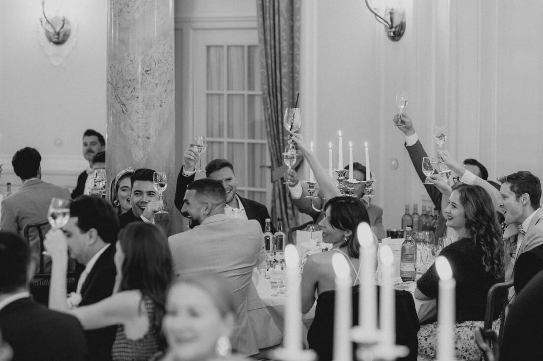 Hochzeitsgäste stoßen im Festsaal des Hotel Bad Schachen in Lindau auf das Brautpaar an.